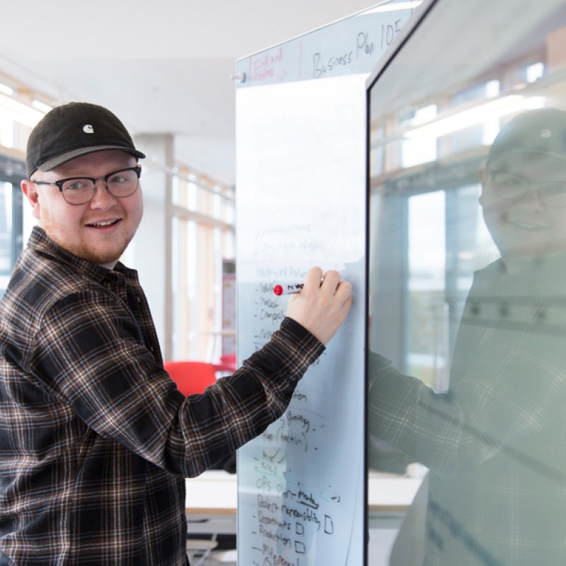 Falmouth University Sustainable Business student writing on a white board